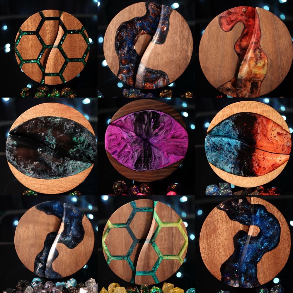Nine round dice boxes with various styles of colorful epoxy in the tops