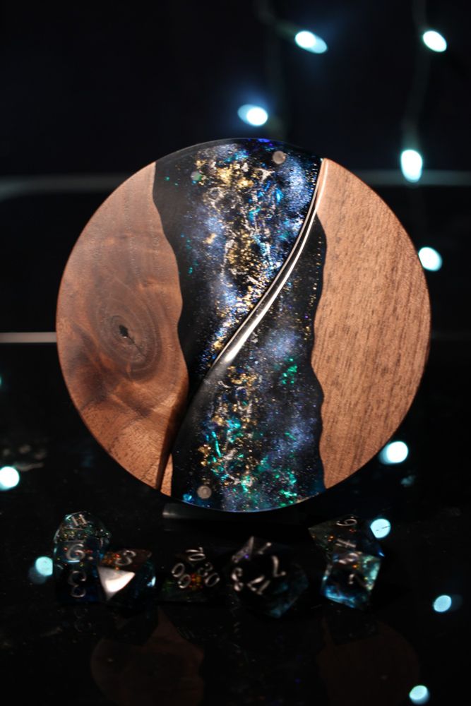 Round walnut dice box with a channel of epoxy running through the top that looks like the Milky Way on a clear night 