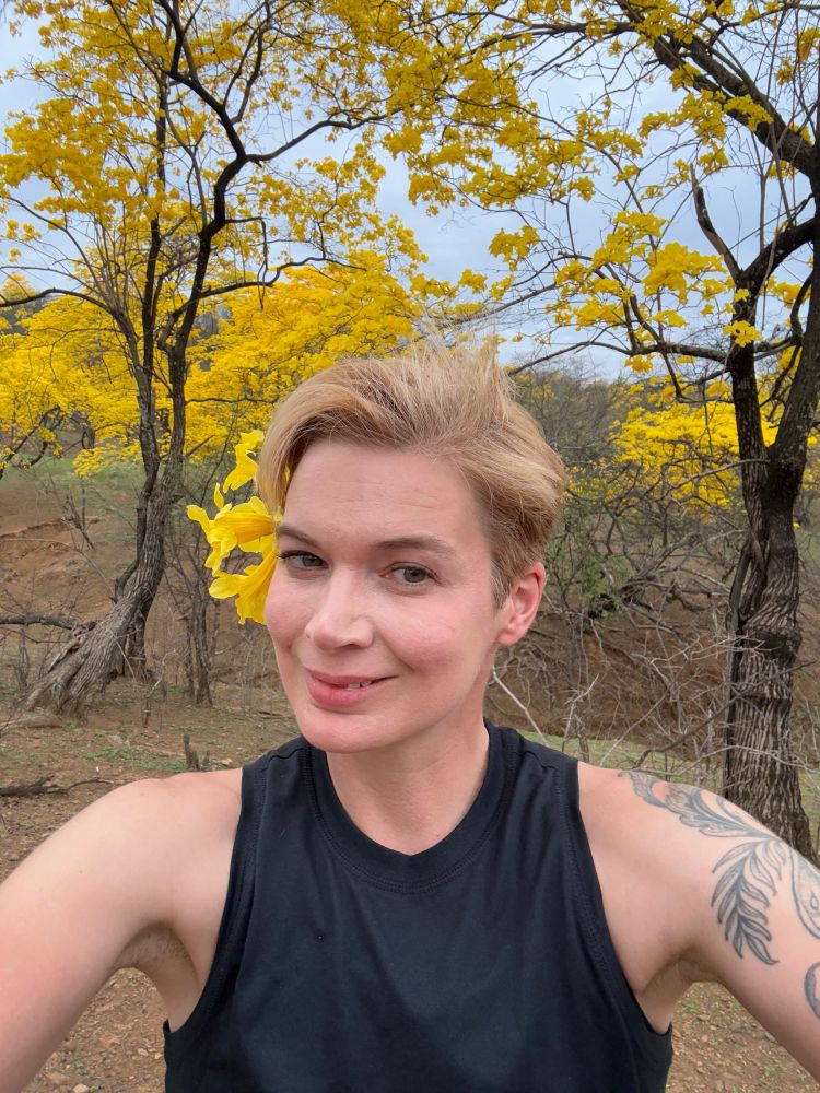 Blond human smiling among Guayacanes trees