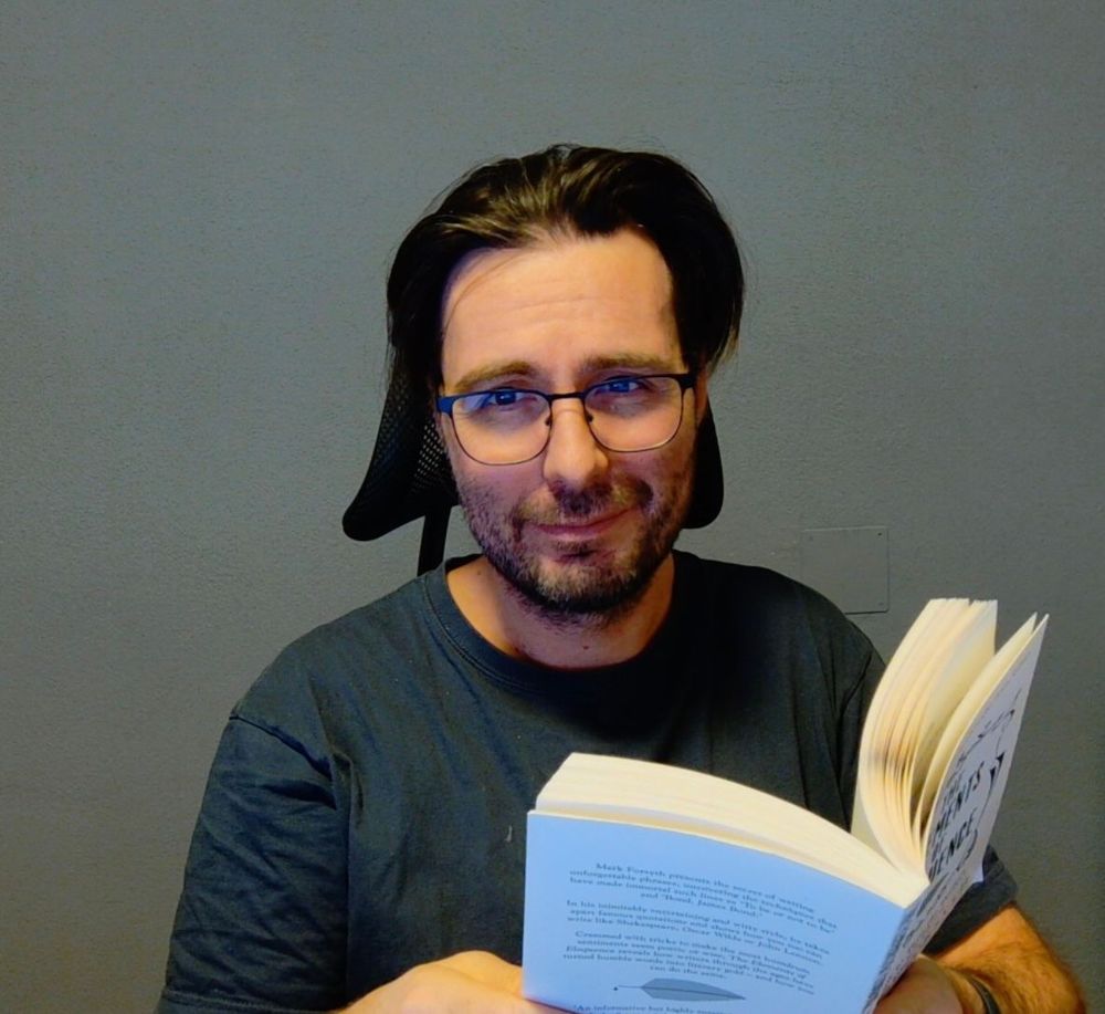 Me, while reading a book behind my desk.