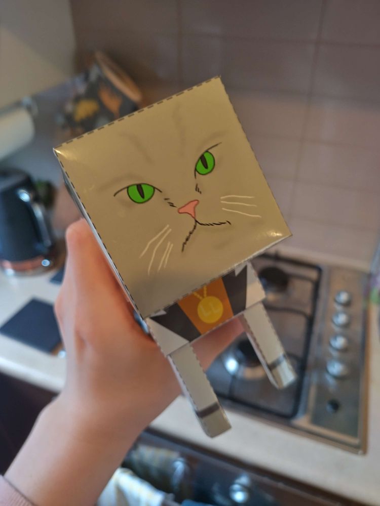 A papercraft Little Lion (by Brendon Chung) being held in my hands. I could obliterate him in an instant. But I have grown to love him for his respectable dealings and absolute adherence to the rule of law.