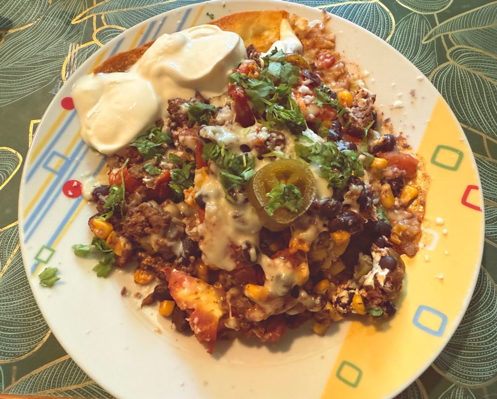 A plate of the same meal from yesterday, decorated with a jalapeno pepper and a dab of sour cream.