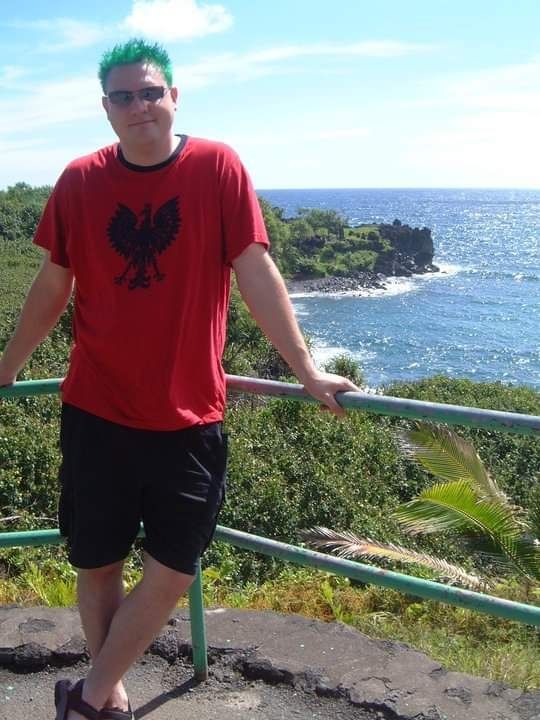 A young Mike with green hair and the Oahu coast in the background.