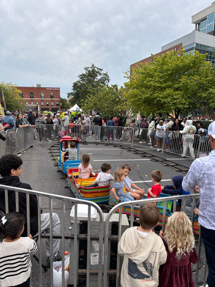 Kids carnival train ride in an insanely busy area