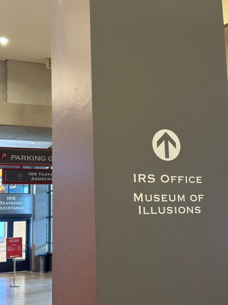 Sign for the IRS office above the Museum of Illusions