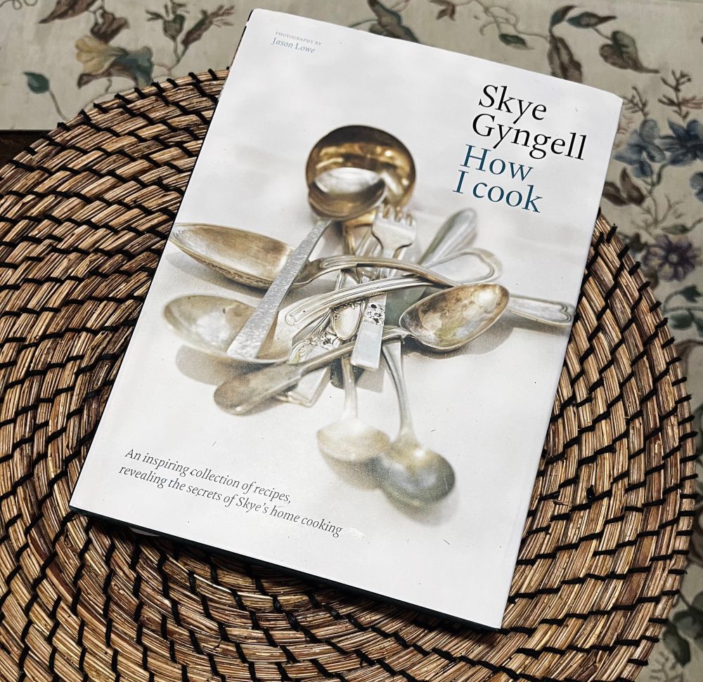 Photo of Skye Gingell’s cookbook, How I Cook. There is a pile of cutlery on the wgite cover.
