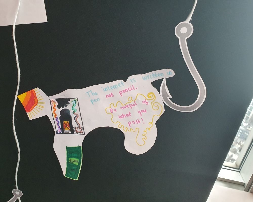 Poster by child that says "The internet is written in pen not pencil. Be careful what you post!"