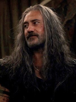 Ed with his hair down looking to the side