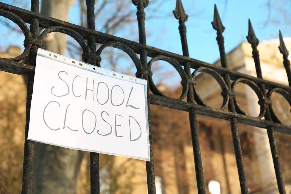 picture of gate with "school closed" sign