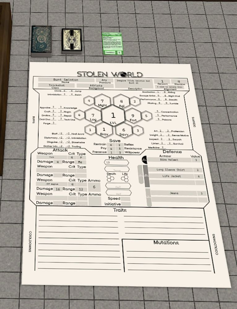Sitting on a grid of grey felt is a tarot deck, a playing card deck, a customized card that's green and the words are too small to make out. 

Below that is a character sheet mostly filled. Bunt Swinton, the Trickshot with the background Athlete. The stats are listed in the middle on the top third of the sheet in a branching honeycomb where each hexagon is progressively smaller. Each branch is a stat commonly found in Pen and Paper RPGs. Beside each stat is the Skills that are associated with the stat. To the sides are some cut ins that give you Buffs and Debuffs on either side, so you can look down and see what issues you might have, like being on fire.

Below in the middle third is the health, attacks, and defenses sheet, showing 4 potentially equipped weapons and multiple different armors, each having an armor value to certain parts of the body which relates to how combat functions. 

Finally in the bottom third is a bunch of horizontal lines for writing on with Traits taking up 3/4ths, and Mutations in the final 1/4 in a smaller box on its own. To either side of these is Cooldowns, where you can put your abilities that are on cooldown.