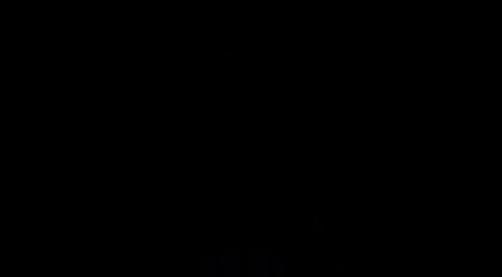 a man in a suit and tie is standing in the dark with his mouth open and the words `` no '' coming out of his mouth .