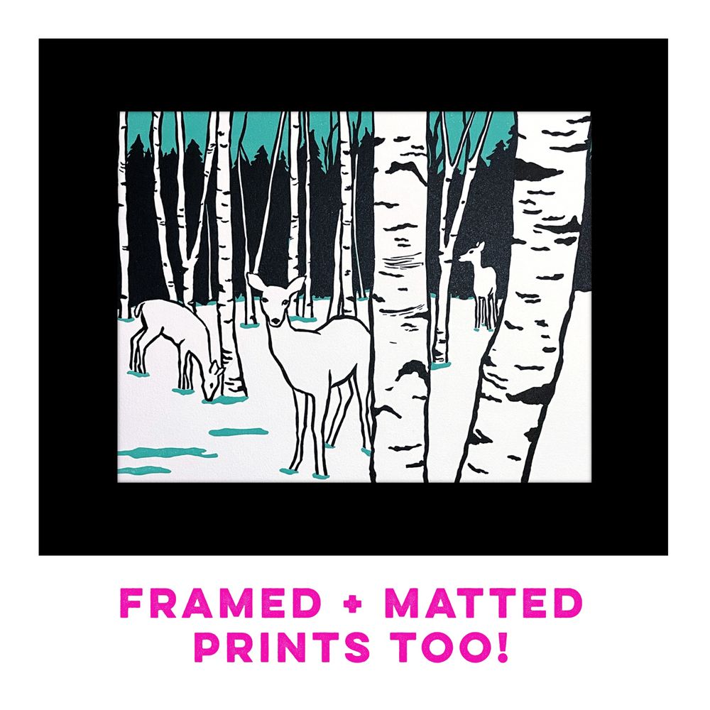 Black, white & aqua colored print of white deer standing amongst paper birch trees. Text reads “framed & matted prints too!”