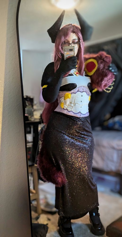Same previous details in other photo in addition a large maroon worm shaped boa scarf over the shoulder