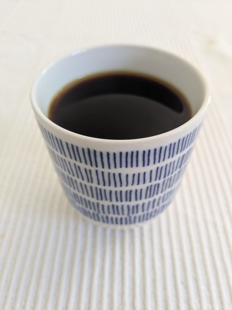 Filter coffee in a rather pretty white and blue china cup. It's white with blue lines in five rows up the cup, as if someone was marking off the days...