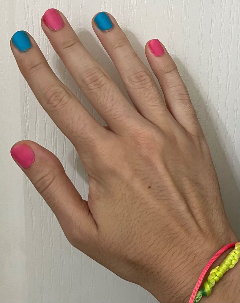 [ID: the matching right hand, but the nail polish alternates pink and blue instead. /end ID.]