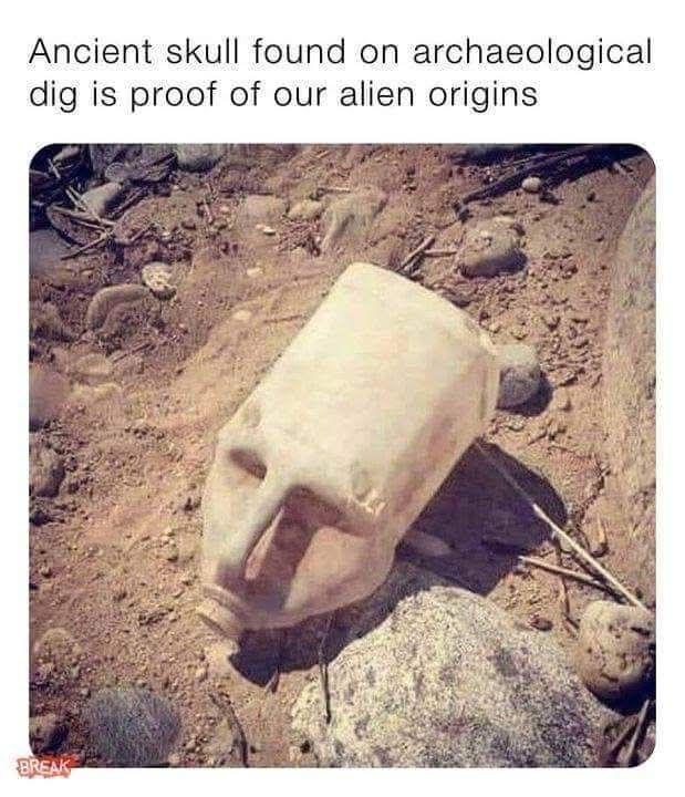 Picture of an upside down jug covered with dirt that resembles a face with an elongated head captioned ancient skull found on archaeological digits proof of our alien origins