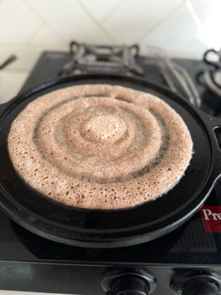 Ghee roast dosa poured out on a pan