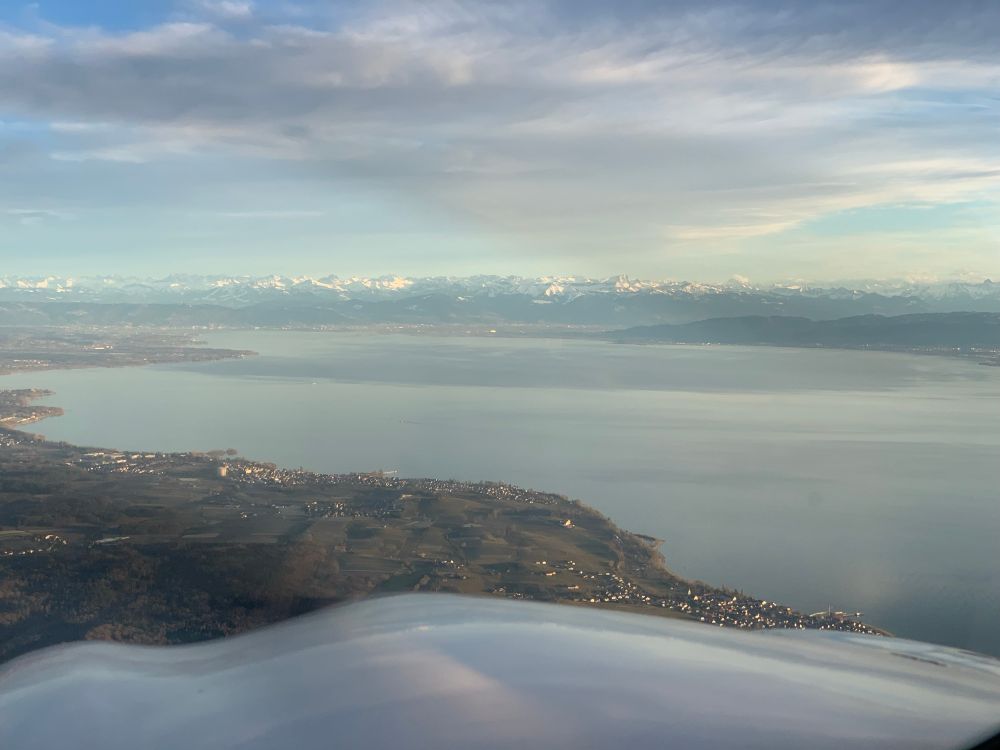Mountains in the distance, seen over the cowling of a P28A in flight. 