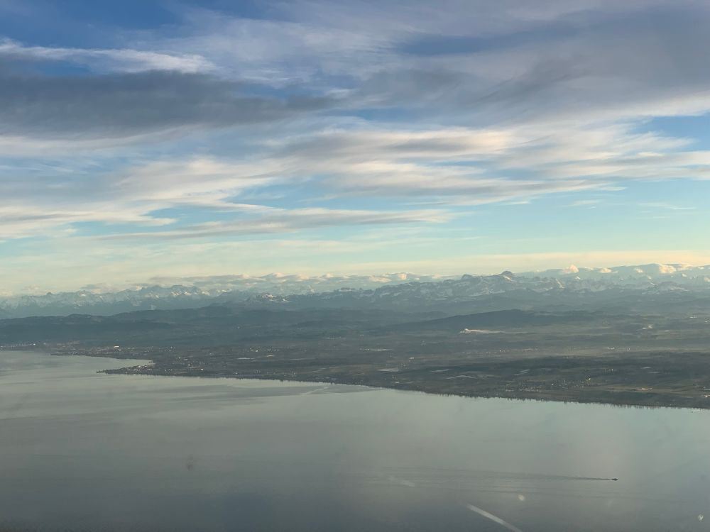A Lake in foreground and snowy mountains in the background. 
