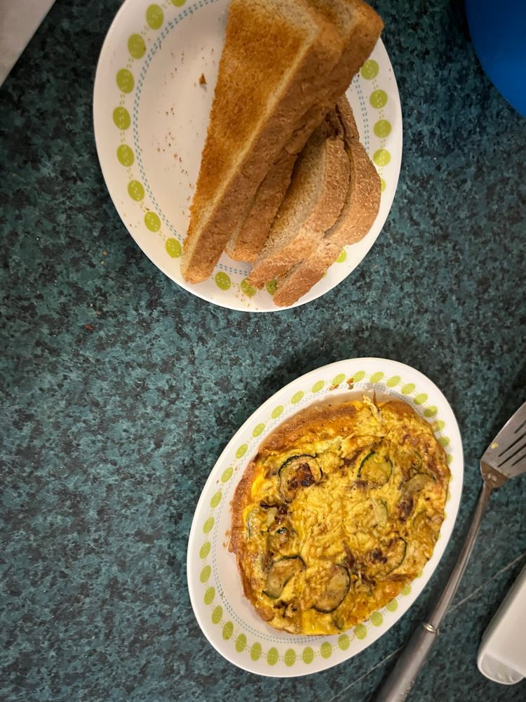 Zucchini and manchego frittata and toast on plates 