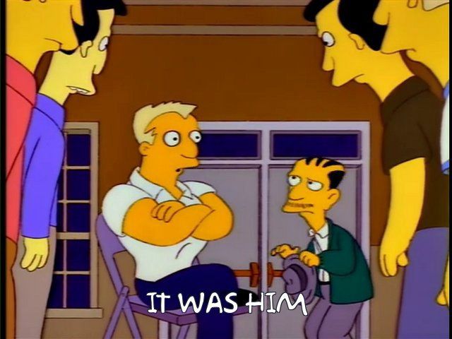 Screenshot from The Simpsons episode “Last Exit to Springfield” with a little odd man pointing to a large handsome man saying “it was him”