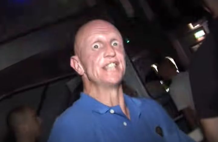 A picture of a man at a rave, eyes so wild and open, he's clearly off his bonce