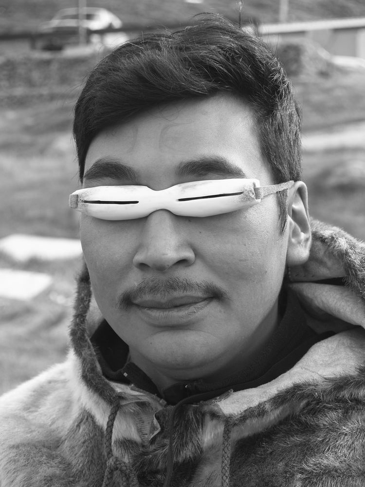 An Inuit hunter wearing early sunglasses