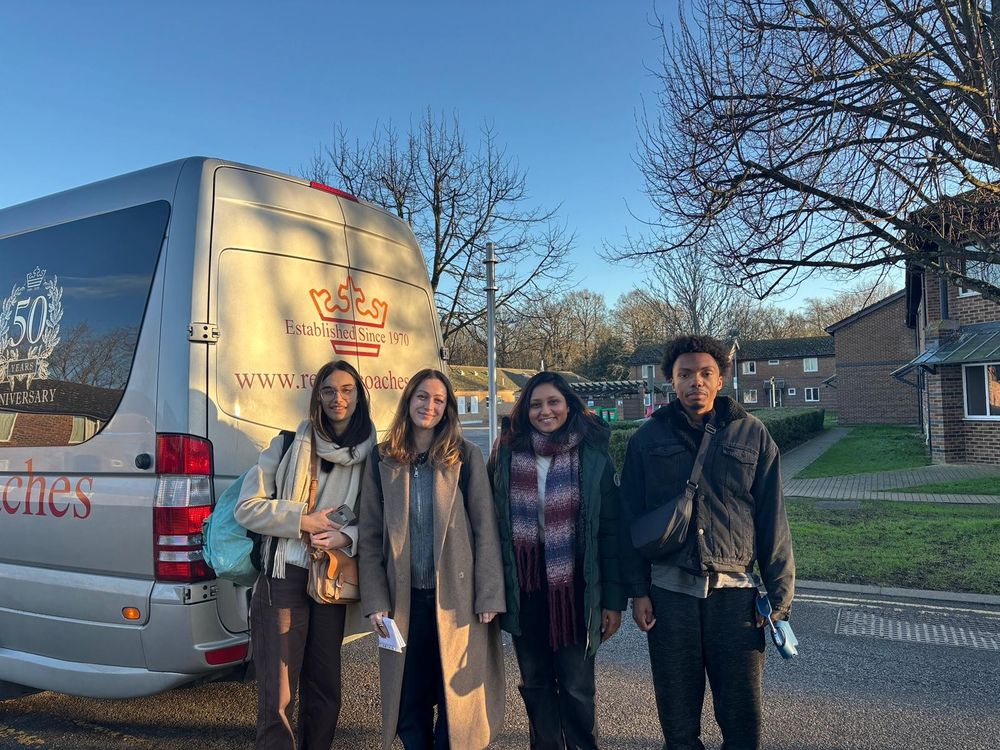 Four new international students smile for a photo as they arrive on the University of Kent Canterbury campus