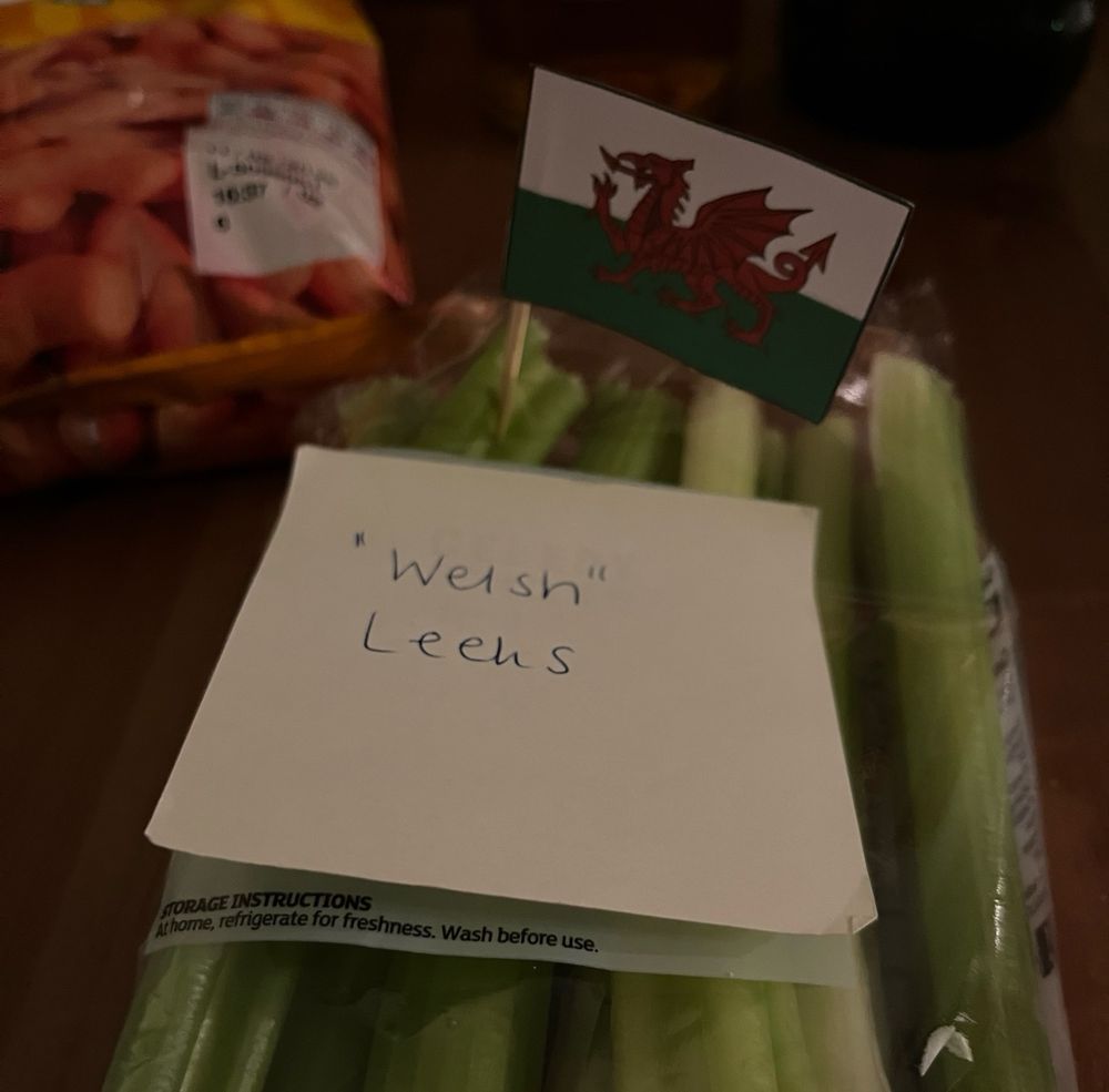 A packet of celery with a post it note saying “Welsh” leeks