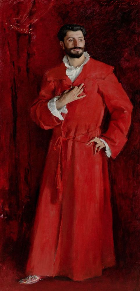 Man wearing a red dressing gown against a red background