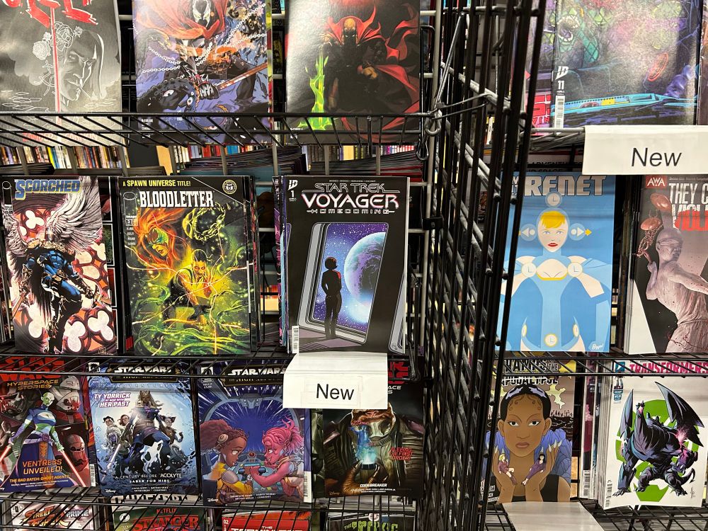 a display of comics for sale including Star Trek voyager homecoming issue 1
