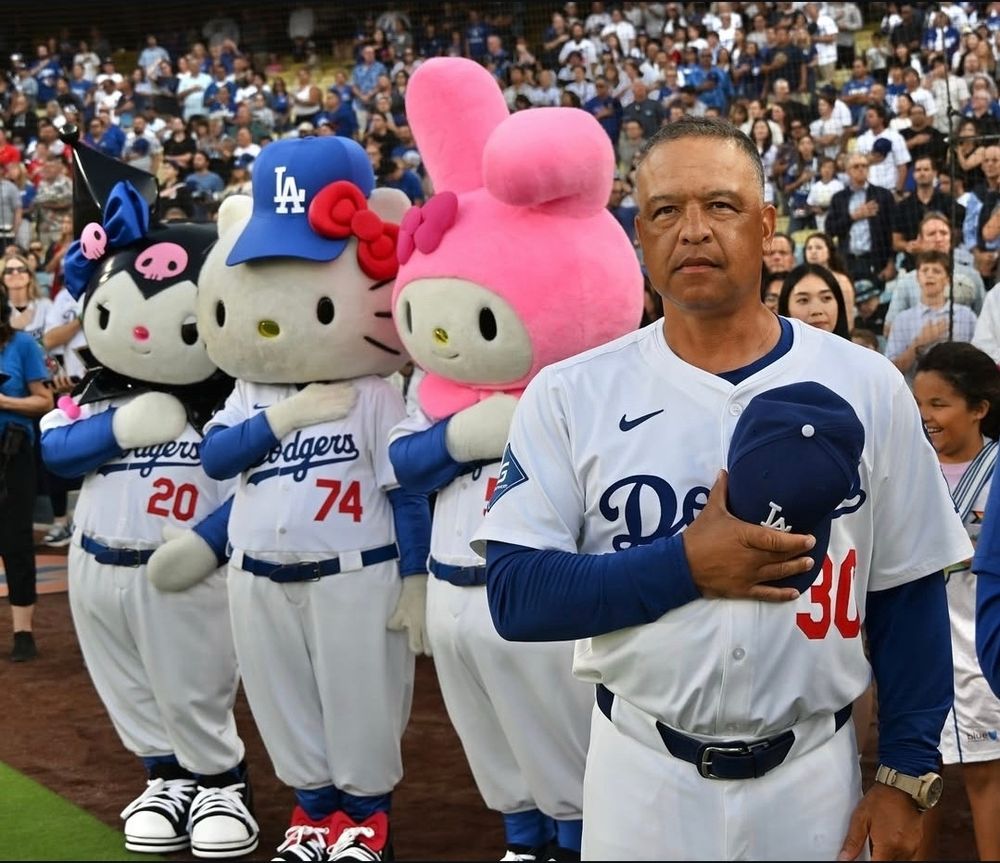 Kuromi, Hello Kitty, and My Melody in the background of Dave Roberts standing for the anthem