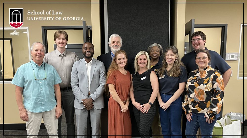 Image shows a group of people standing together inside during a 2024 pop-up legal clinic in Troup County, Georgia. 