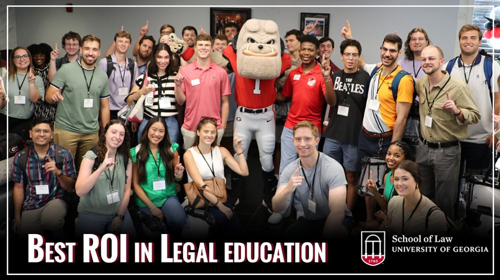 Image shows law students with UGA mascot Hairy Dawg during orientation in August 2025. Several students and Hairy Dawg are holding up one finger to indicate being #1. 