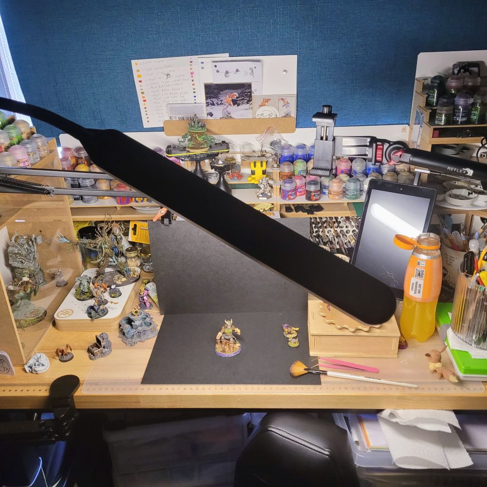 Craft desk with hobbyzone units, in the centre of the desk is my turtle neck light at an angle pointing at two pieces of card working as a backdrop for taking pictures of minitures. 