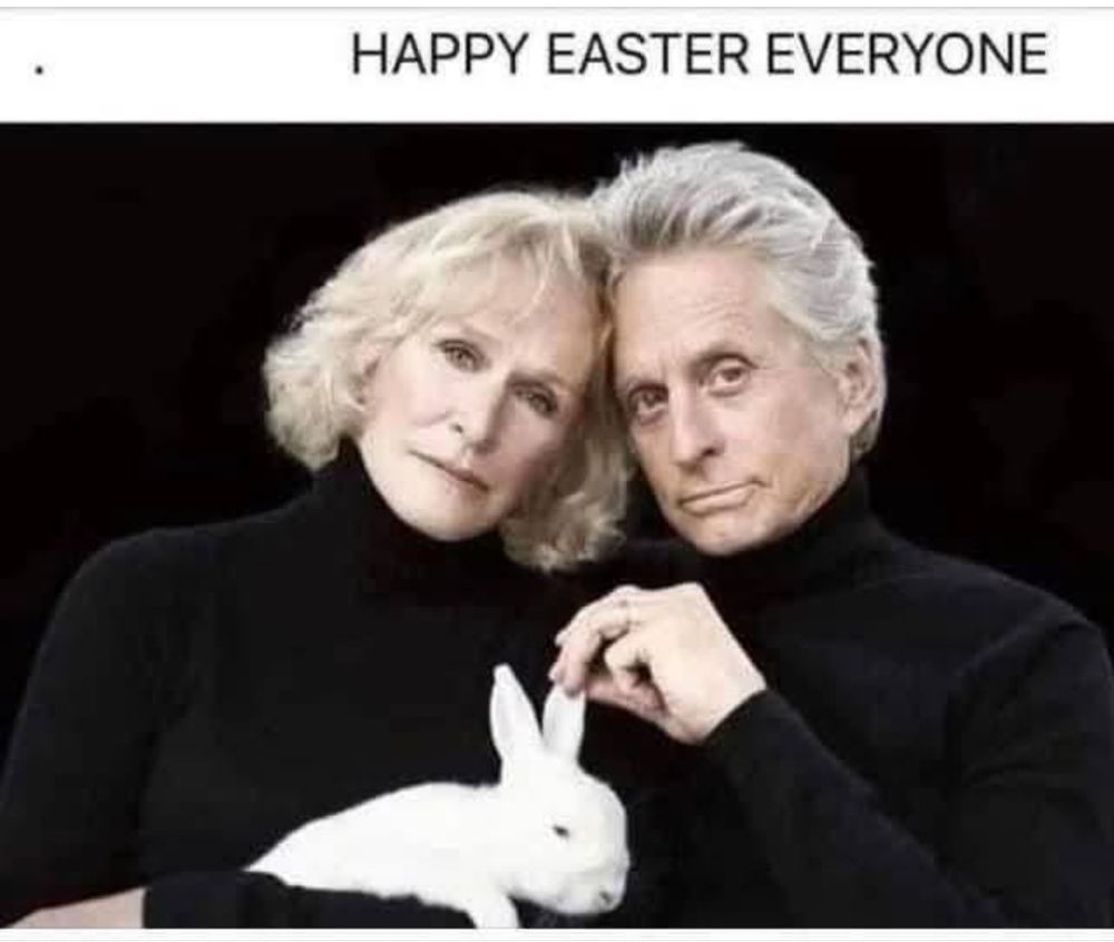 Glenn Close and Michael Douglas holding a rabbit. 
