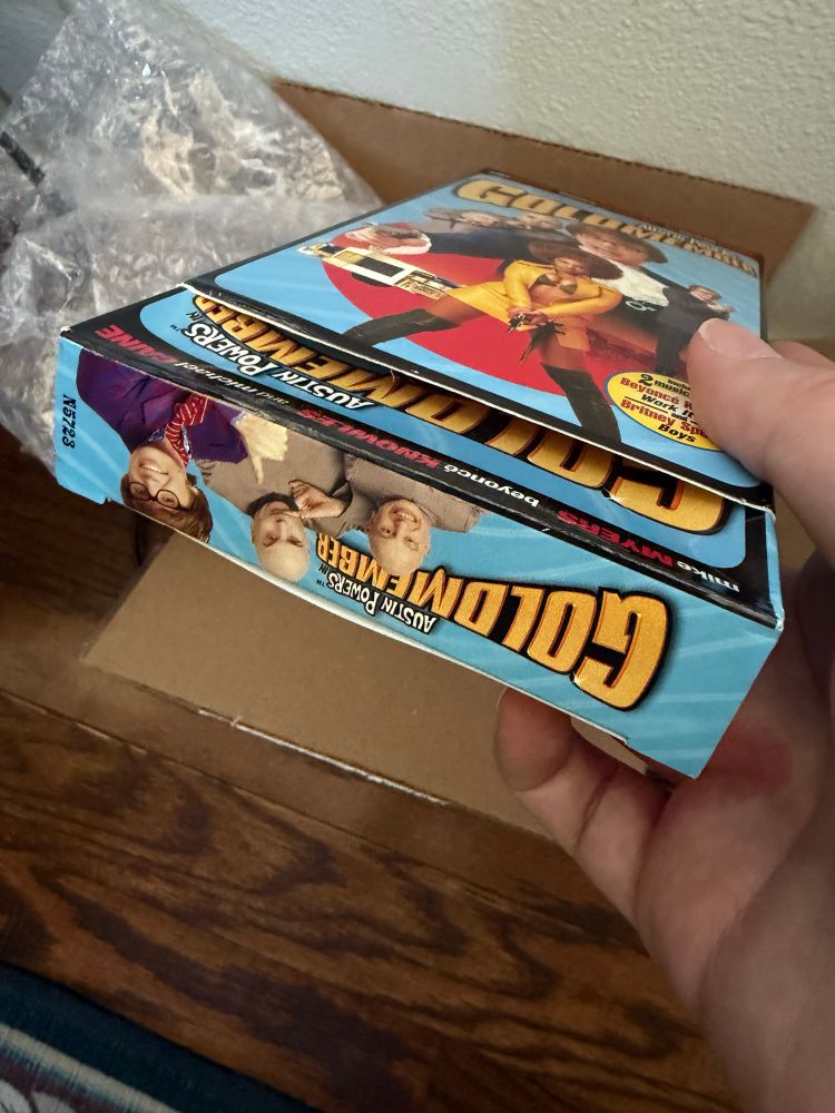 Austin Powers Goldmember VHS box poking out of an Austin Powers Goldmember VHS box.