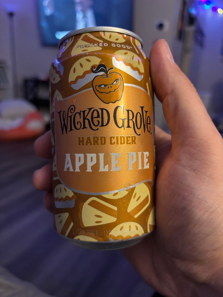 A hand holding a can of Wicked Grove Hard Cider Apple Pie