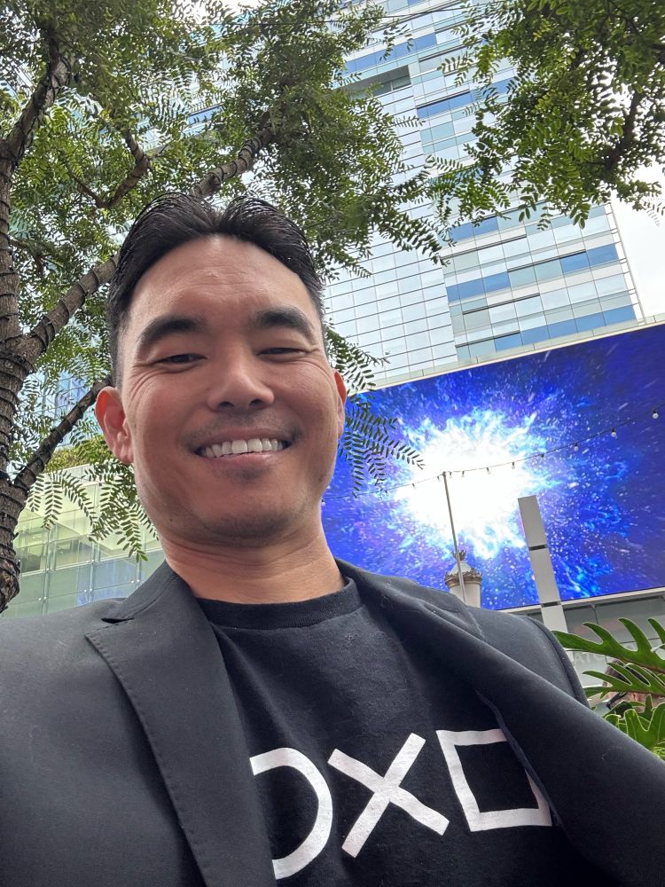 At the game awards with a suit jacket and my PlayStation symbols shirt.
