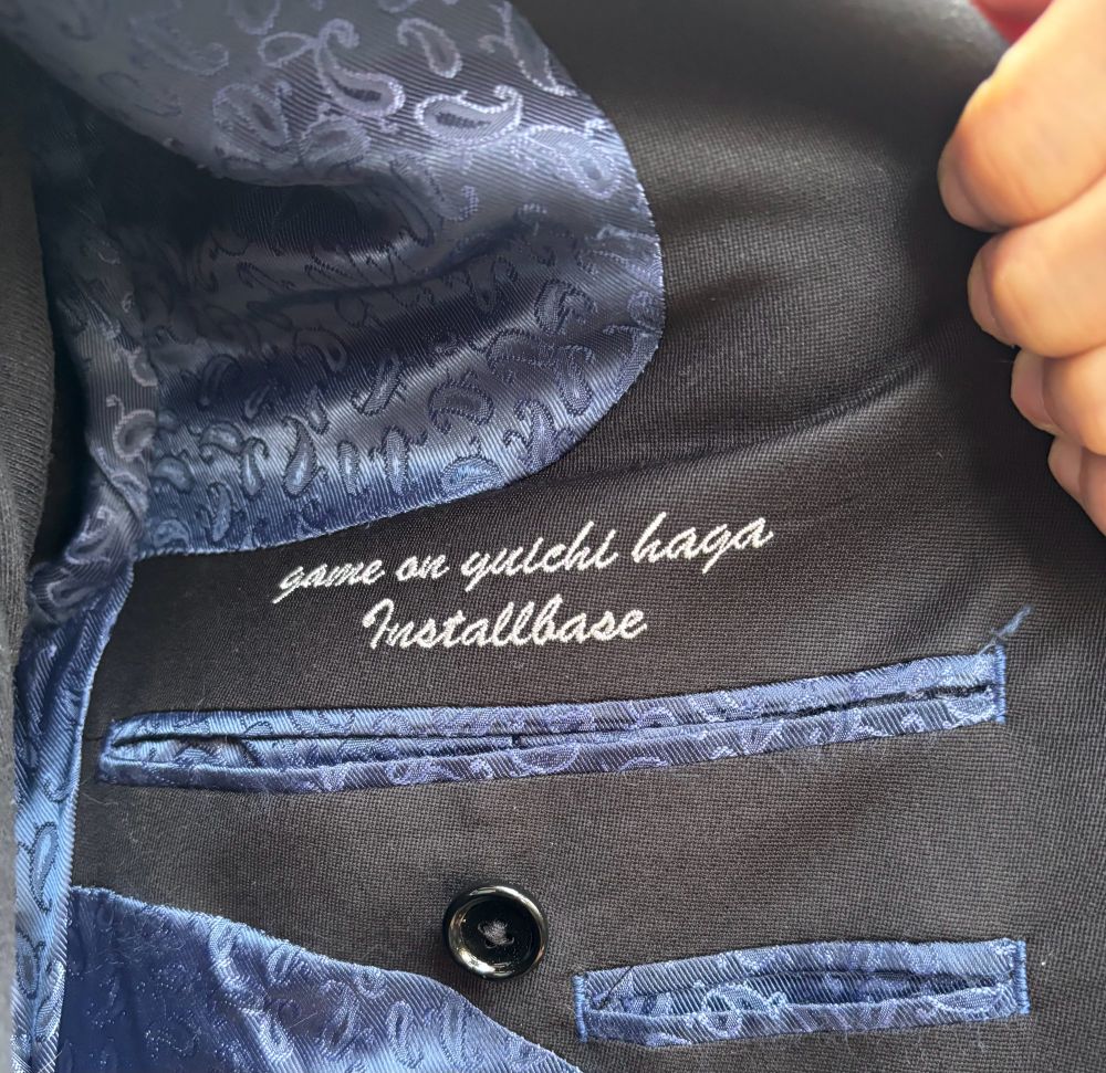 Embroidered suit jacket says Game On 
