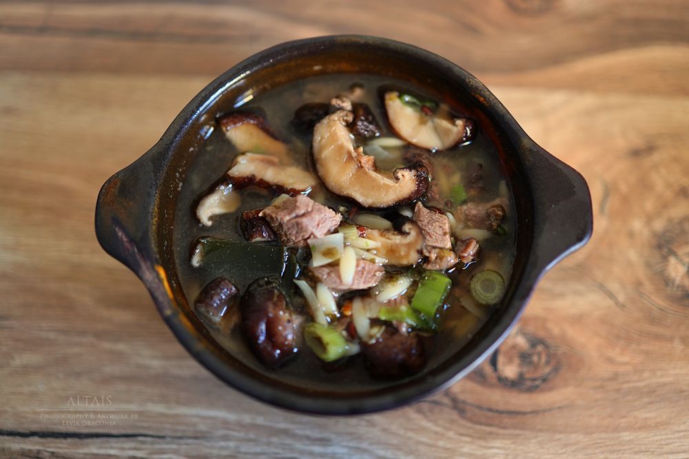 Brown bowl with shiitake, kombu/nori, orzo, onions and venison.