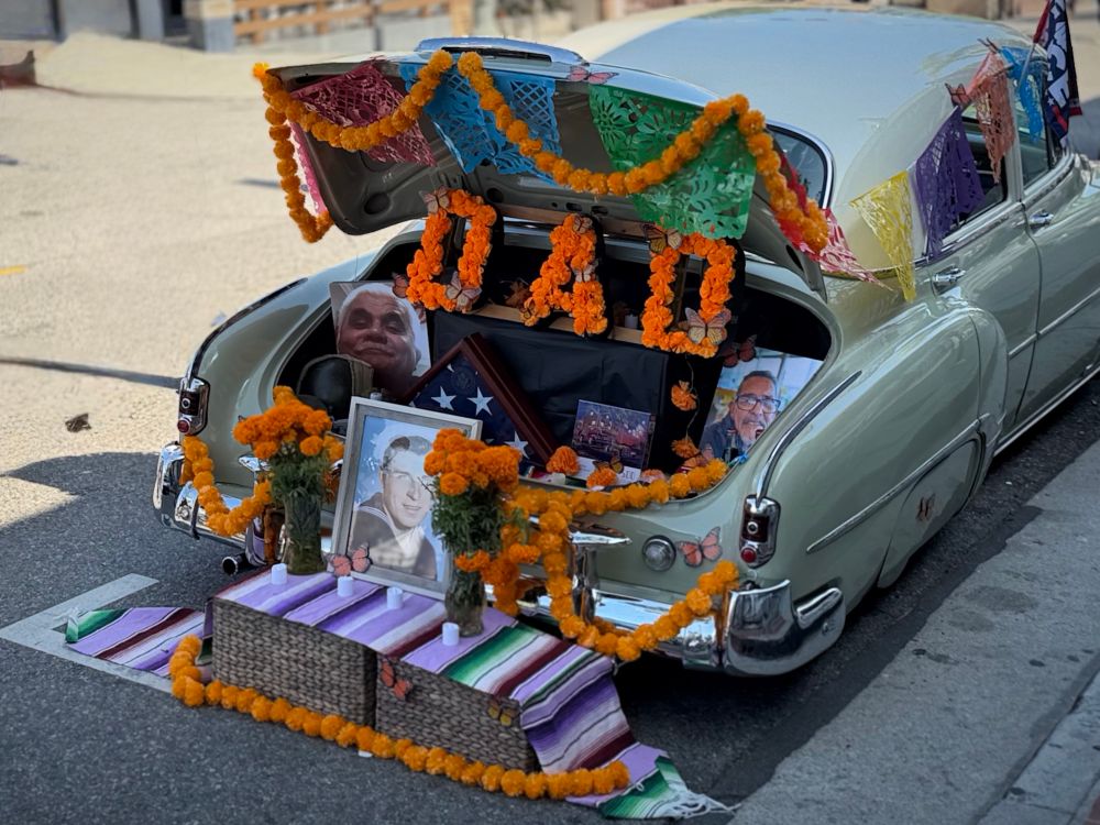Flowers that say, dad and pictures of a man in the back of a classic car