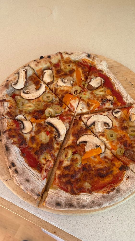 Sliced sourdough pizza on a board