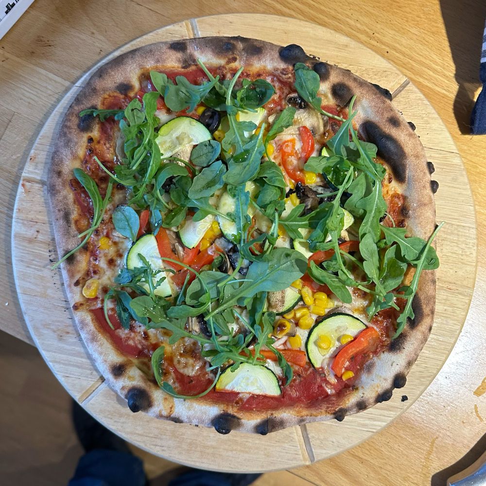 A sourdough pizza with rocket on top
