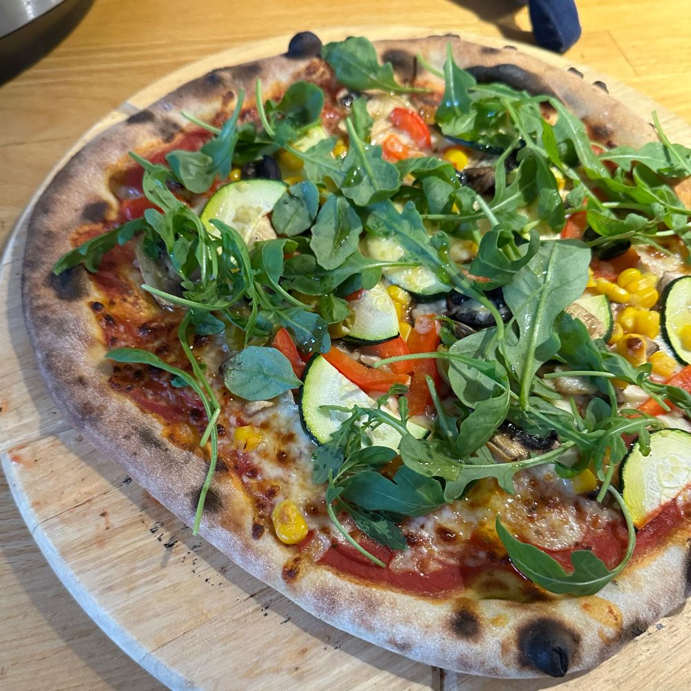 A sourdough pizza with rocket on top