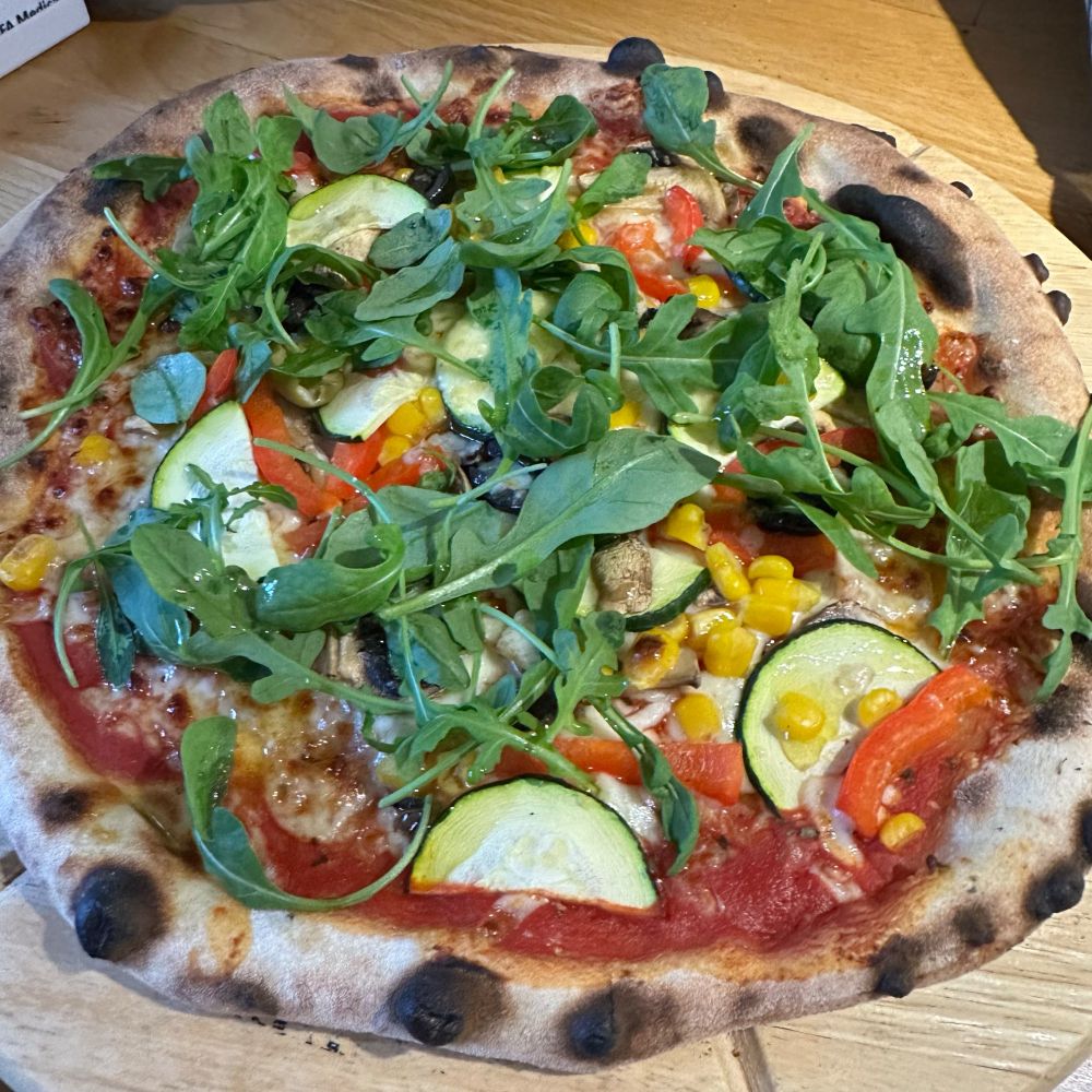 A sourdough pizza with rocket on top