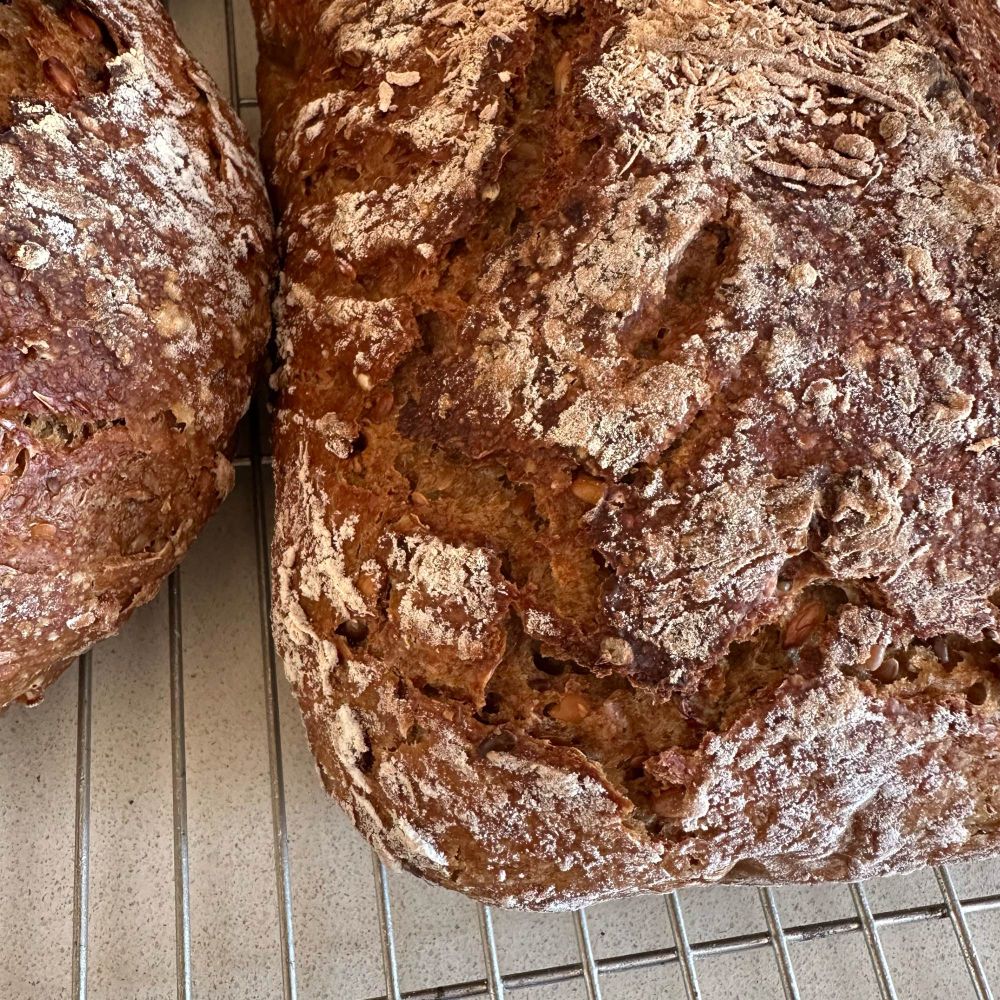 A baked hard sourdough with wheat scoring 