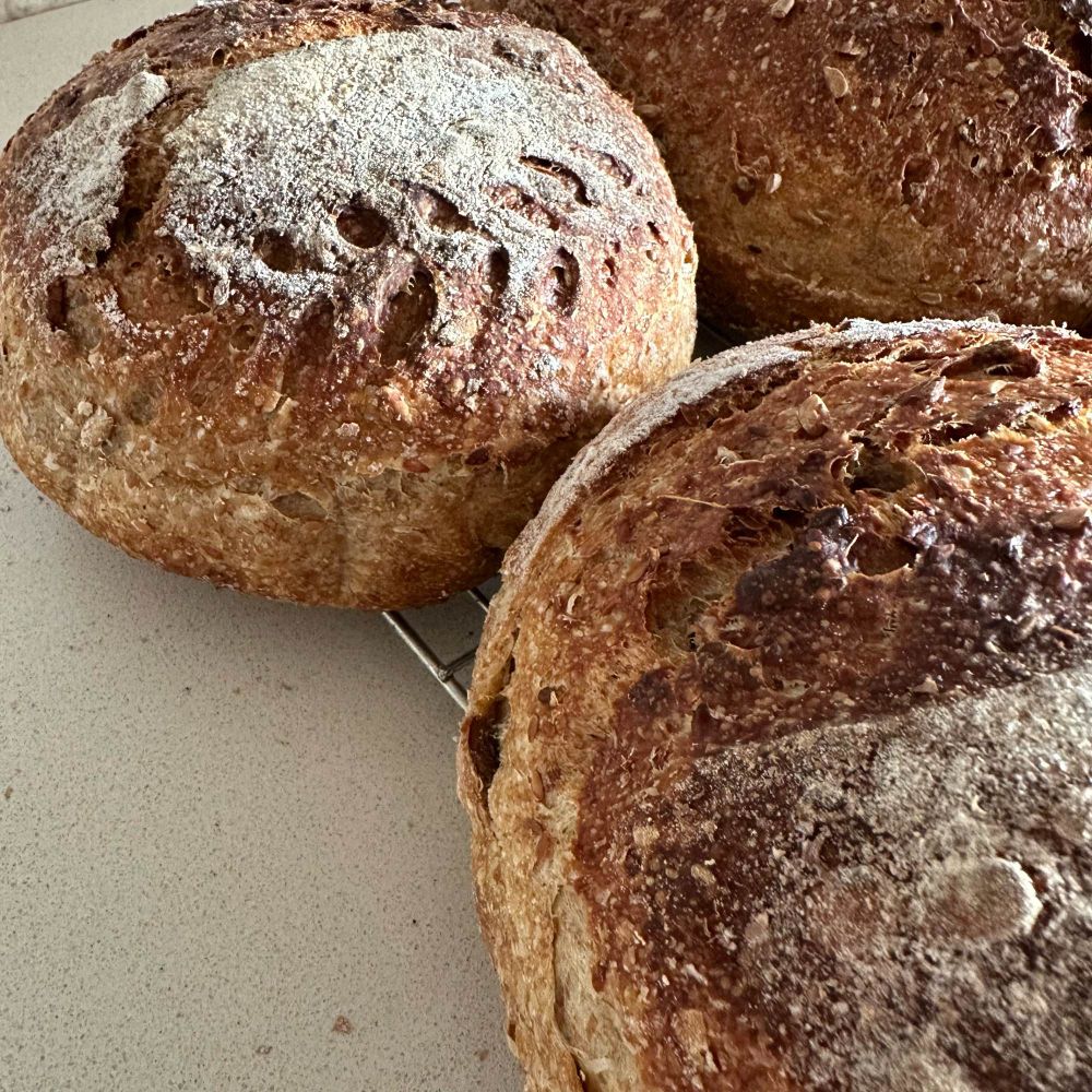 Scored seeded wholemeal sourdough loaves