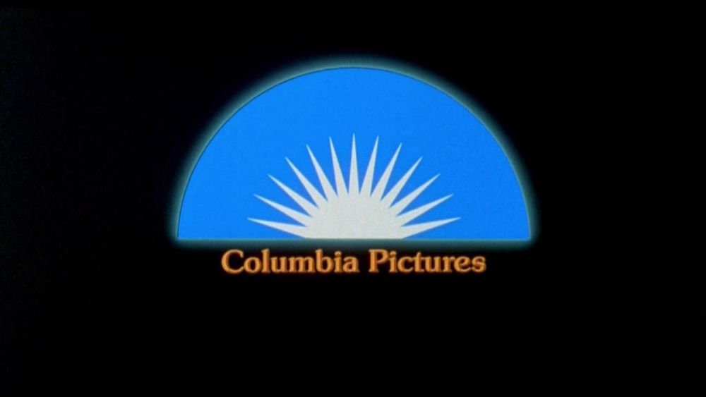 1970s Columbia Pictures logo depicting a rising sun design against a blue semicircle background 
