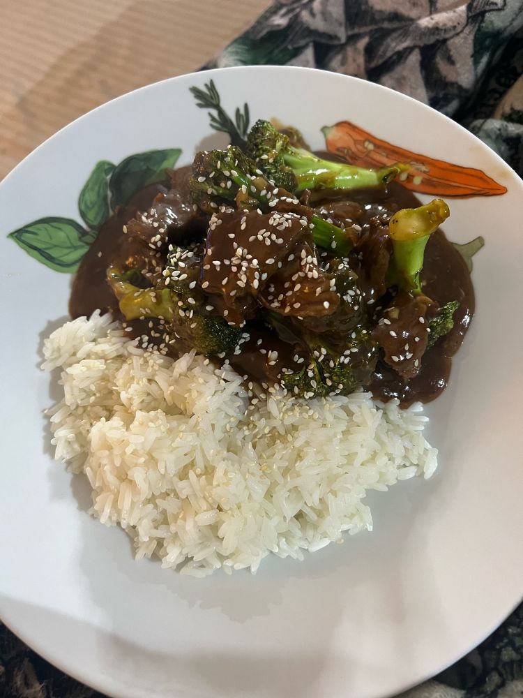 Plate of food, beef and broccoli with rice